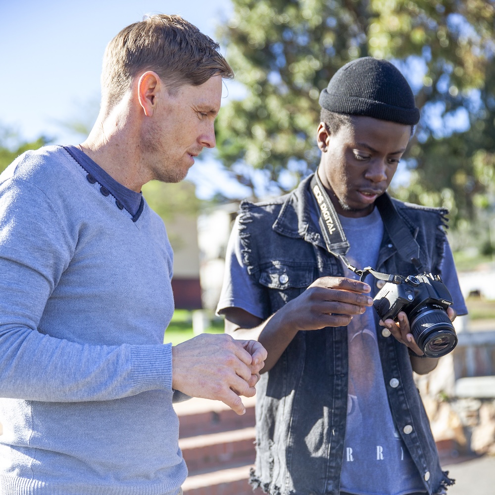 Youth learning photography skills at Ibali workshop in South Africa
